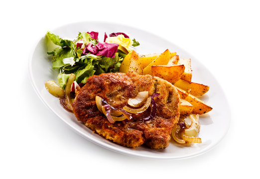 Fried pork chop with potatoes on white background