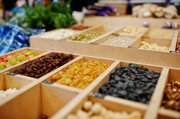 Raisins, nuts and candied fruits on the shelf of a supermarket or grocery store.