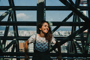 Caucasian young woman walking by the train station of Kyoto. Discovering the architecture, playing with the reflections in the crystals and admiring the view from the top floor. Lifestyle.