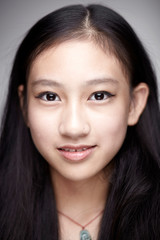 Fototapeta premium Asian teenage girl portrait. Indoors white background