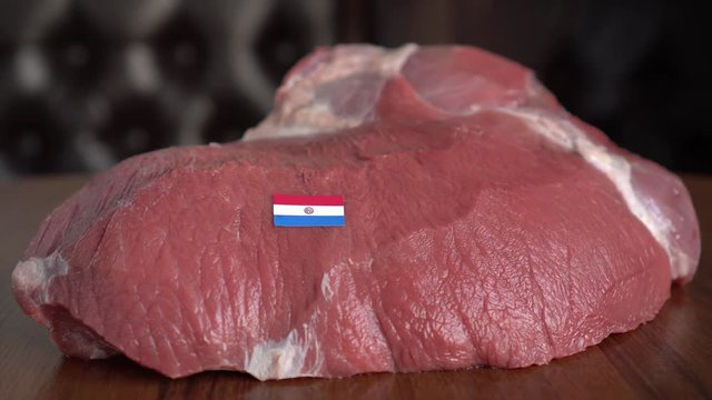Raw meat and flag of Paraguay. Beef and Cattle. Global trade