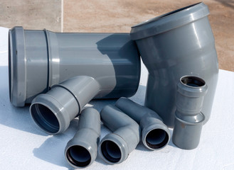 Composition from plastic sewer pipes, isolated on a white