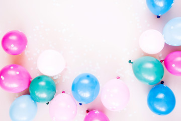 Fototapeta na wymiar Colorful balloons on pastel color background. Festive or birthday party concept. Flat lay, top view.