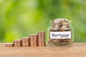 Coin stack, and money jar on white background mortgage saving concept