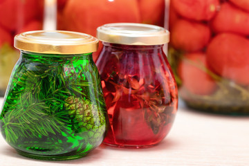 Jam of fir twigs and cones and mountain cranberries in small jars