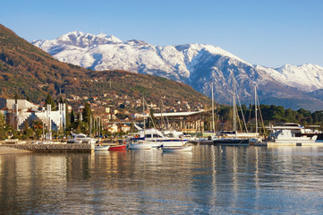 Beautiful winter Mediterranean landscape. Montenegro, Adriatic Sea, Bay of Kotor. View of snow-capped peaks of Lovcen mountain and Tivat city