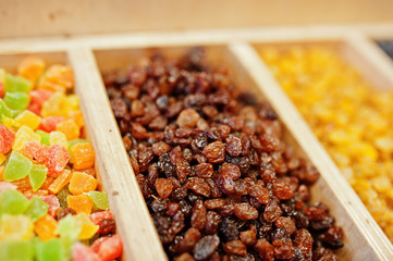Raisins and candied fruits on the shelf of a supermarket or grocery store.
