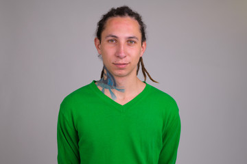 Portrait of young handsome man with dreadlocks