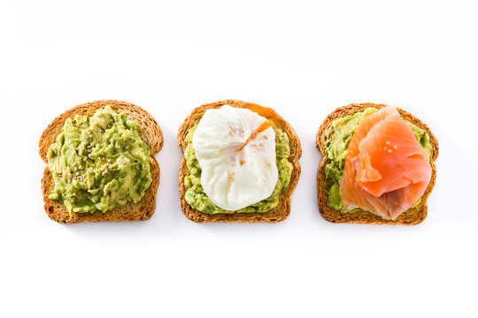 Toasted breads with avocado, poached eggs and salmon isolated on white background. Top view.