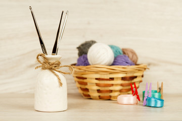Balls of yarn for knitting on a light wooden background. Decorations for Valentine's Day and Mother's Day. Romantic atmosphere.