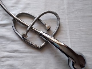 the arrow of sanitary Cupid breaks heart of the plumber is made of water hoses for a sink, a metal braid of steel color, St. Valentine's Day, St. Valentine, the top view isolate, largely - obrazy, fototapety, plakaty