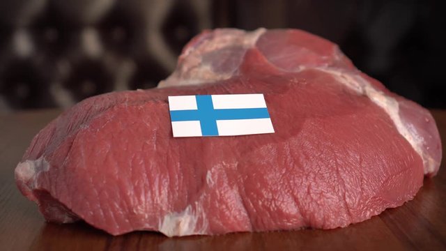 Raw meat and flag of Finland. The Beef Industry. Production and international trad