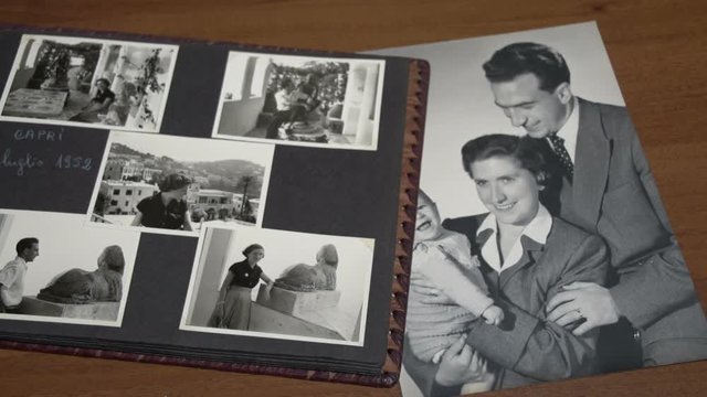 Slow Motion Of Browsing Vintage Album With A Lot Of Photos Of Mother, Father And Son FDV