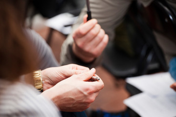 Two communicate in the office: the girl holds the pen in hand