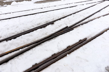 Railway tracks in frosty winter covered with snow