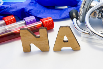 Sodium in serum or blood in basic metabolic test. Laboratory test tubes with blood, stethoscope,...