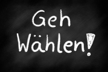 Fototapeta premium Go voting, german lettering on a blackboard