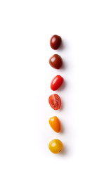 Cherry tomatoes colorful variation lined up on a white background viewed from above. Top view