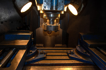 closeup machine tool in metal factory with industrial drilling cnc machines