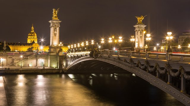 Bridge Pont Alexandre III at night, in the back Hotel des Invalides with dome Invalidendom, Paris, France, Europe