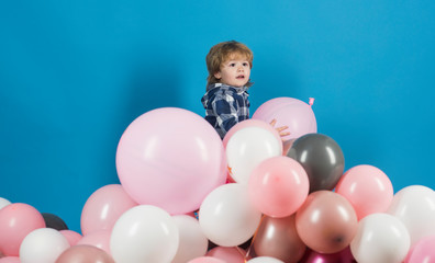 Fototapeta na wymiar Boy and balloons. Pink and blue children's background. Happy game on balls mountain. Free game. Happy child. Entertainment Center. Birthday of the child. Cute baby. Gifts and products for children