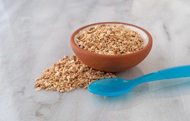 Cut orris root in a bowl with a spoon to the side