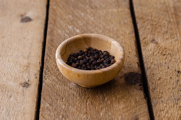 Fototapeta na wymiar Black pepper peas in a bamboo bowl.