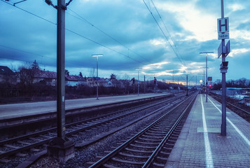 A small,quiet train station in the early evening