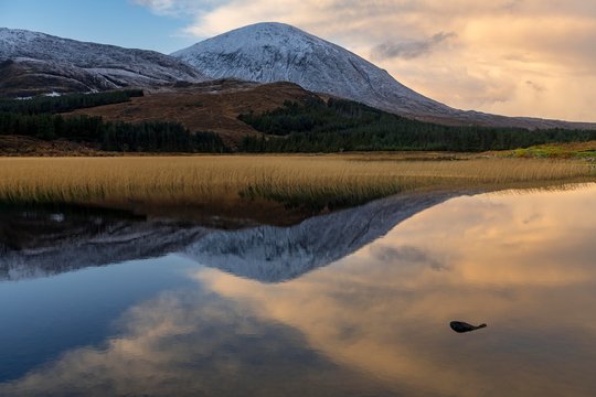 Reflection in Loch Cill Chrisod, in Highland landscape with winter Cullins mountains, Broadford, Isle of Skye, United Kingdom, Europe