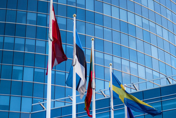 EU flags in front of a skyscraper in Riga, Latvia