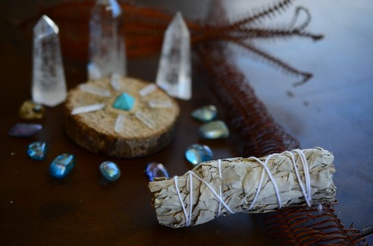 Hipster healing crystal display, bright shiny gems and stones. Witchy crystal healing and meditation. Sacred space, Wiccan alter. Clear quartz, aquaaura, rainbow aura quartz. 