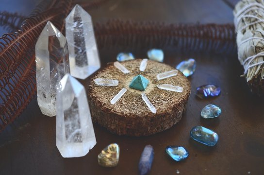 Hipster healing crystal display, bright shiny gems and stones. Witchy crystal healing and meditation. Sacred space, Wiccan alter. Clear quartz, aquaaura, rainbow aura quartz. 