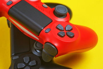 Fragment of buttons of two gamepad on a yellow background close-up.