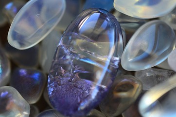 Beautiful, bright tumbled crystal chips. Stunning healing crystals. Macro photograph, low exposure. Hand holding crystals, bright healing crystals. Crisp colors and lighting, clear quartz