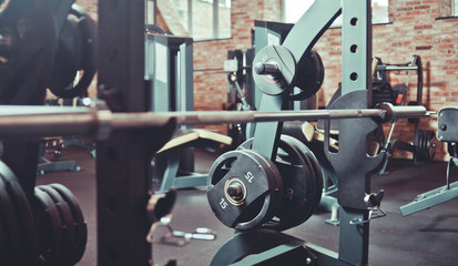 Fototapeta premium Barbells close up at gym. Sports equipment in gym, interior
