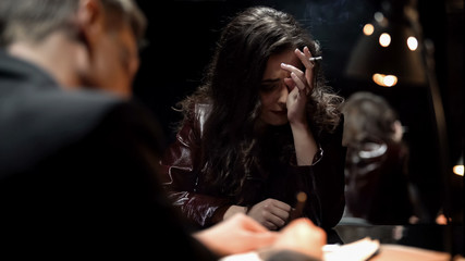 Desperate lady crying after finding out about husbands murder, writing testimony