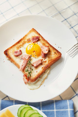 Homemade delicious american breakfast with sunny side up fried egg, toast, sausage. English breakfast with fried eggs, bacon, sausages and toasts. Breakfast on Valentine. Good morning concept.