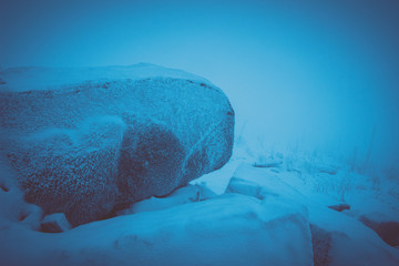 snowy landscape in the mountains, darkness and mist