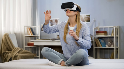 College girl having fun wearing virtual reality glasses, modern technology