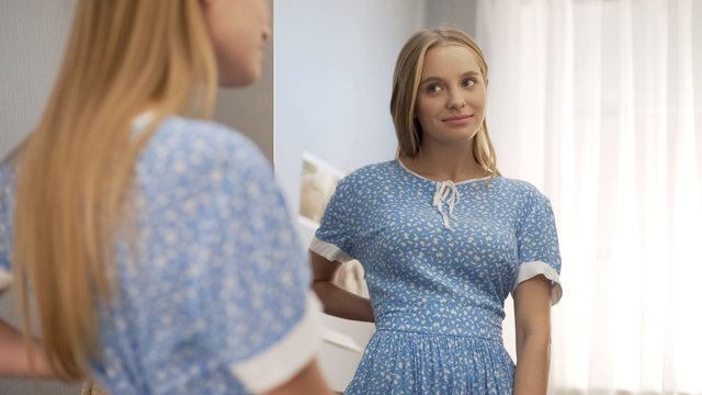 School Girl Trying On Old Mothers Dress And Looking In Mirror, Future Stylist