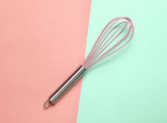 Kitchen corolla on blue coral pastel background. Top view, cooking concept, minimalism.