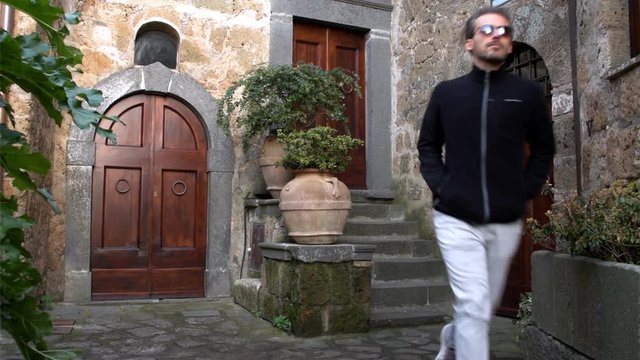 A slow motion of  young man running that appears and disappears in front of three doors as a strange resonance  SF