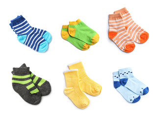 Set of cute colorful child socks on white background, top view. Baby accessories