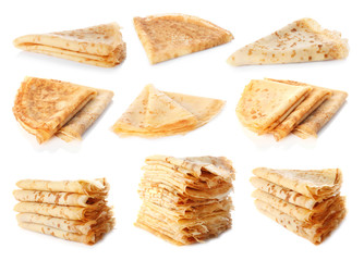 Set of folded tasty thin pancakes on white background
