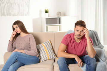Fototapeta premium Young couple with relationship problems in living room