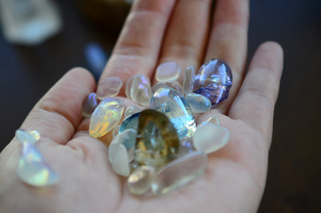 Hipster healing crystal display, bright shiny gems and stones. Witchy crystal healing and meditation. Sacred space, Wiccan alter. Clear quartz, aquaaura, rainbow aura quartz. 
