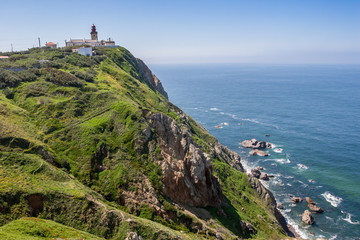 Fototapeta na wymiar Lighthouse on cliffs at Cabo da Roca (Cape Roca) in Portugal