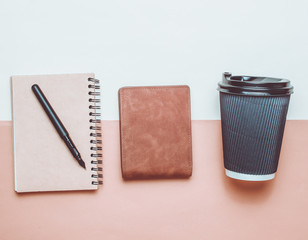 Cup of coffee, notepad with pen, purse on a beige brown paper background. Business concept, journalism, top view, minimalism