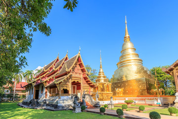 Fototapeta premium Chapel and golden pagoda at Wat Phra Singh Woramahawihan in Chiang Mai, North of Thailand