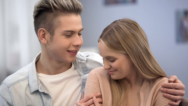 Boy Embracing Shy Girl, Looking At Her With Love, Inexperience In Teen Relations